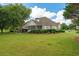 Spacious backyard and screened-in porch with outdoor seating and mature landscaping at 9634 Coastal Pointe Dr, Villa Rica, GA 30180