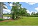Beautiful backyard with a bench overlooking the pond and golf course at 9634 Coastal Pointe Dr, Villa Rica, GA 30180