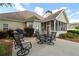 Back patio and outdoor seating, screened-in porch and mature landscaping at 9634 Coastal Pointe Dr, Villa Rica, GA 30180