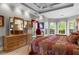 Elegant bedroom with tray ceiling, bay window, and beautiful wooden dresser at 9634 Coastal Pointe Dr, Villa Rica, GA 30180