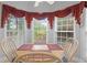 Breakfast nook bathed in sunlight from large windows with views of the surrounding landscape at 9634 Coastal Pointe Dr, Villa Rica, GA 30180