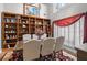 Bright dining room featuring hardwood floors, custom built-ins, and traditional furniture at 9634 Coastal Pointe Dr, Villa Rica, GA 30180