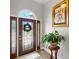 Stylish foyer with elegant front door, hardwood floors, and tasteful decor with a beautiful plant stand at 9634 Coastal Pointe Dr, Villa Rica, GA 30180