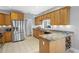 Spacious kitchen with granite countertops, stainless appliances, and a wine rack at 9634 Coastal Pointe Dr, Villa Rica, GA 30180