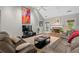 Bright living room features a stone fireplace and plush couches at 9634 Coastal Pointe Dr, Villa Rica, GA 30180