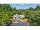 Beautiful community pool with bath house and lounge chairs surrounded by mature trees at 9634 Coastal Pointe Dr, Villa Rica, GA 30180