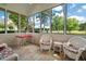 Bright sunroom with stylish wicker furniture, large windows, and beautiful views of the water at 9634 Coastal Pointe Dr, Villa Rica, GA 30180