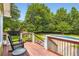 View from the porch of the backyard featuring a wooden deck and an in-ground pool at 180 Moseley Crossing Dr, Stockbridge, GA 30281