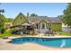 The beautiful backyard features an in-ground pool, and a covered outdoor bar at 180 Moseley Crossing Dr, Stockbridge, GA 30281