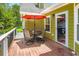 Outdoor patio features a dining table set for outdoor dining, with an umbrella at 180 Moseley Crossing Dr, Stockbridge, GA 30281