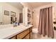 Clean bathroom with a single vanity, a shower with curtain, and linen storage at 180 Moseley Crossing Dr, Stockbridge, GA 30281