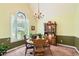 Traditional dining room with a decorative window, classic chandelier, and elegant wood furniture at 180 Moseley Crossing Dr, Stockbridge, GA 30281