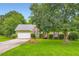 Charming single-Gathering home with a lush green lawn, mature trees, and well-maintained landscaping at 180 Moseley Crossing Dr, Stockbridge, GA 30281