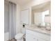 Bright bathroom featuring a granite countertop, and modern fixtures at 2686 Ne Almand Ne Ln, Conyers, GA 30013