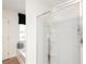 Bathroom with white shower enclosure and frosted glass, next to a luxurious tub and a window with black shades at 2686 Ne Almand Ne Ln, Conyers, GA 30013
