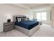 Bright bedroom featuring a plush, king-sized bed with a blue quilt, stylish nightstands, and a comfy chaise lounge near the window at 2686 Ne Almand Ne Ln, Conyers, GA 30013