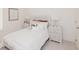 Bright bedroom features a bed with white bedspread and neutral decor; natural light streams in through a window at 2686 Ne Almand Ne Ln, Conyers, GA 30013