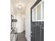 Inviting entryway with a gray door, modern lighting fixture, and stylish decor at 2686 Ne Almand Ne Ln, Conyers, GA 30013