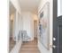 Hallway with three mirrors, gray chair, and modern artwork at 2686 Ne Almand Ne Ln, Conyers, GA 30013