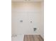 Bright laundry room with white walls, shelving, and hookups for a washer and dryer at 2686 Ne Almand Ne Ln, Conyers, GA 30013