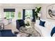 Bright living room featuring stylish blue accent chairs, a white couch, and modern decor at 2686 Ne Almand Ne Ln, Conyers, GA 30013