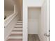Staircase view with white railing and a closet with an open door at 2686 Ne Almand Ne Ln, Conyers, GA 30013