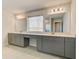 A bathroom with a double vanity, grey cabinets and large mirrors at 100 Homesite Valleyview Ct, Mcdonough, GA 30252