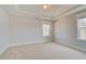 Bright bedroom with carpeted floors, crown molding, and a large window at 100 Homesite Valleyview Ct, Mcdonough, GA 30252