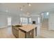 Modern kitchen with island, pendant lights, stainless steel appliances, and an open floor plan at 100 Homesite Valleyview Ct, Mcdonough, GA 30252