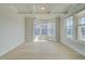 Bright living room featuring tray ceiling, bay window, and wood-look flooring at 100 Homesite Valleyview Ct, Mcdonough, GA 30252
