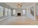 Spacious living room with fireplace, large windows, hardwood floors, and staircase at 100 Homesite Valleyview Ct, Mcdonough, GA 30252