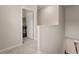 Second floor laundry room with neutral walls and carpet leading to front loading washer and dryer units behind an open door at 2170 Trelipe Dr, Lawrenceville, GA 30044