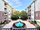 A courtyard view of condos surrounding a fountain and lush landscaping at 3635 E Paces Ne Cir # 1405, Atlanta, GA 30326