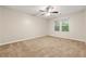 Bright bedroom with plush carpeting, neutral walls, and a ceiling fan for added comfort at 10545 Virginia Pine Ln, Alpharetta, GA 30022