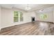 Bright living room featuring a fireplace, hardwood floors and large windows overlooking the trees at 10545 Virginia Pine Ln, Alpharetta, GA 30022