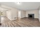 Open-concept living area with hardwood floors and a cozy fireplace, perfect for Gathering gatherings at 10545 Virginia Pine Ln, Alpharetta, GA 30022