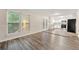Inviting living room with hardwood floors, connecting seamlessly to the modern, white kitchen at 10545 Virginia Pine Ln, Alpharetta, GA 30022