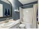 Well-lit full bathroom boasts a large mirror, sink, toilet and shower-tub combo at 142 Holly Mill Village Dr, Canton, GA 30114
