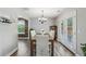 Dining room with wood floors, a chandelier, and large French doors leading to outdoor area at 142 Holly Mill Village Dr, Canton, GA 30114