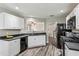 Updated kitchen with white cabinets, dark counters, stainless steel appliances, and wood floors at 142 Holly Mill Village Dr, Canton, GA 30114