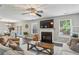 Bright living room featuring a cozy fireplace, neutral decor, and wood-look flooring at 142 Holly Mill Village Dr, Canton, GA 30114