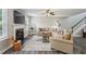 Bright living room featuring a cozy fireplace, neutral decor, and wood-look flooring at 142 Holly Mill Village Dr, Canton, GA 30114