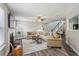 Bright living room featuring a cozy fireplace, neutral decor, and wood-look flooring at 142 Holly Mill Village Dr, Canton, GA 30114