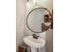 Charming powder room with a unique round mirror at 142 Holly Mill Village Dr, Canton, GA 30114