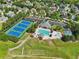 Aerial view of community amenities: pool, tennis courts, basketball court, parking, and clubhouse at 2452 Stone Manor Ne Dr, Buford, GA 30519