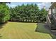 Expansive backyard featuring well-maintained lawn space, and mature trees for privacy and shade at 2452 Stone Manor Ne Dr, Buford, GA 30519