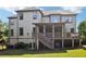 Spacious backyard with a deck, a covered porch with an outdoor seating area, and stairs at 2452 Stone Manor Ne Dr, Buford, GA 30519