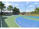 Community basketball court featuring painted surface surrounded by trees and grass at 2452 Stone Manor Ne Dr, Buford, GA 30519
