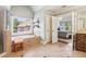 Bright bathroom featuring tile flooring, double sinks, a glass shower, and soaking tub at 2452 Stone Manor Ne Dr, Buford, GA 30519