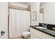 Bathroom featuring tiled shower, toilet, vanity and black countertop at 2452 Stone Manor Ne Dr, Buford, GA 30519